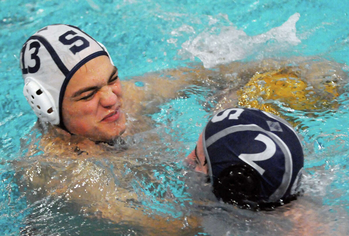 Staples' water polo captain Angus Armstrong battles with teammate Kirk O'Halloran during practice at the school in Westport, Conn., Oct. 18, 2012.