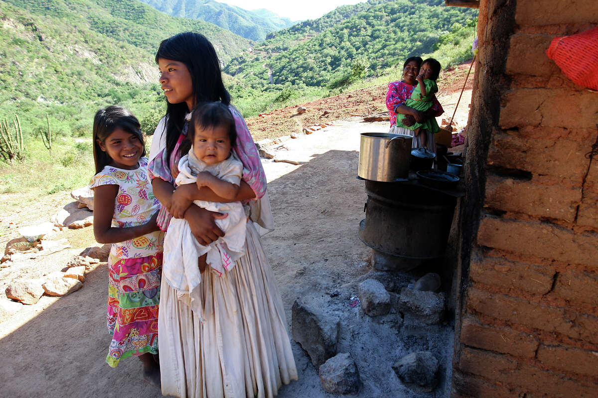 A Tarahumara family’s interest is piqued by a visit from a Batopilas government official to El Arenal de Las Lupes settlement in the Mexican Sierra Tarahumara.