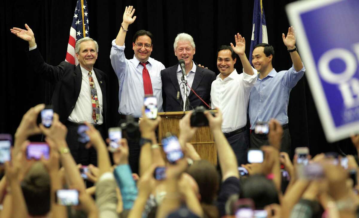 Former President Bill Clinton, center, surrounded by Lloyd Doggett, left to right, Pete Gallego, Julian Castro, and Joaquin Castro, greet the crowd at South San High School in San Antonio to show support for Pete Gallego and other Democrats running in the upcoming election. Thursday, Oct. 25, 2012.