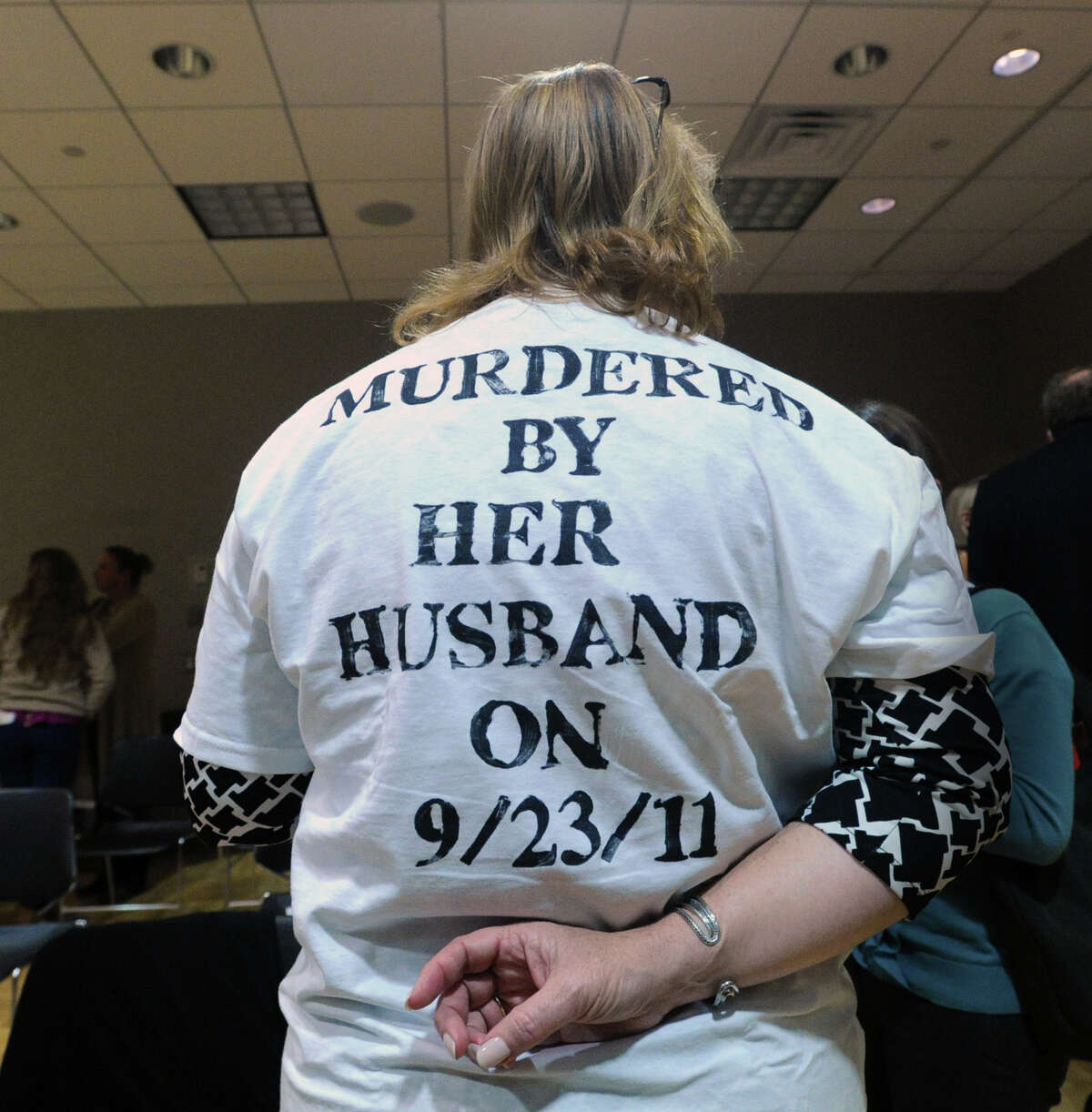 Lisa Corvese of Greenwich wears a shirt honoring the memory of Milford resident, Catherine Fox, who was killed by her husband on 9/23/11, during the YWCA Domestic Abuse Services in Greenwich, Thursday night, Oct. 25, 2012.
