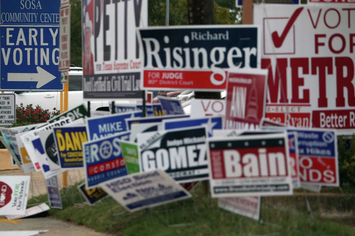 Campaign signs litter the area outside early voting at the Harris County Precinct 3 Trini Mendenhall Sosa Community Center Friday, Oct. 26, 2012, in Houston. ( Johnny Hanson / Houston Chronicle )