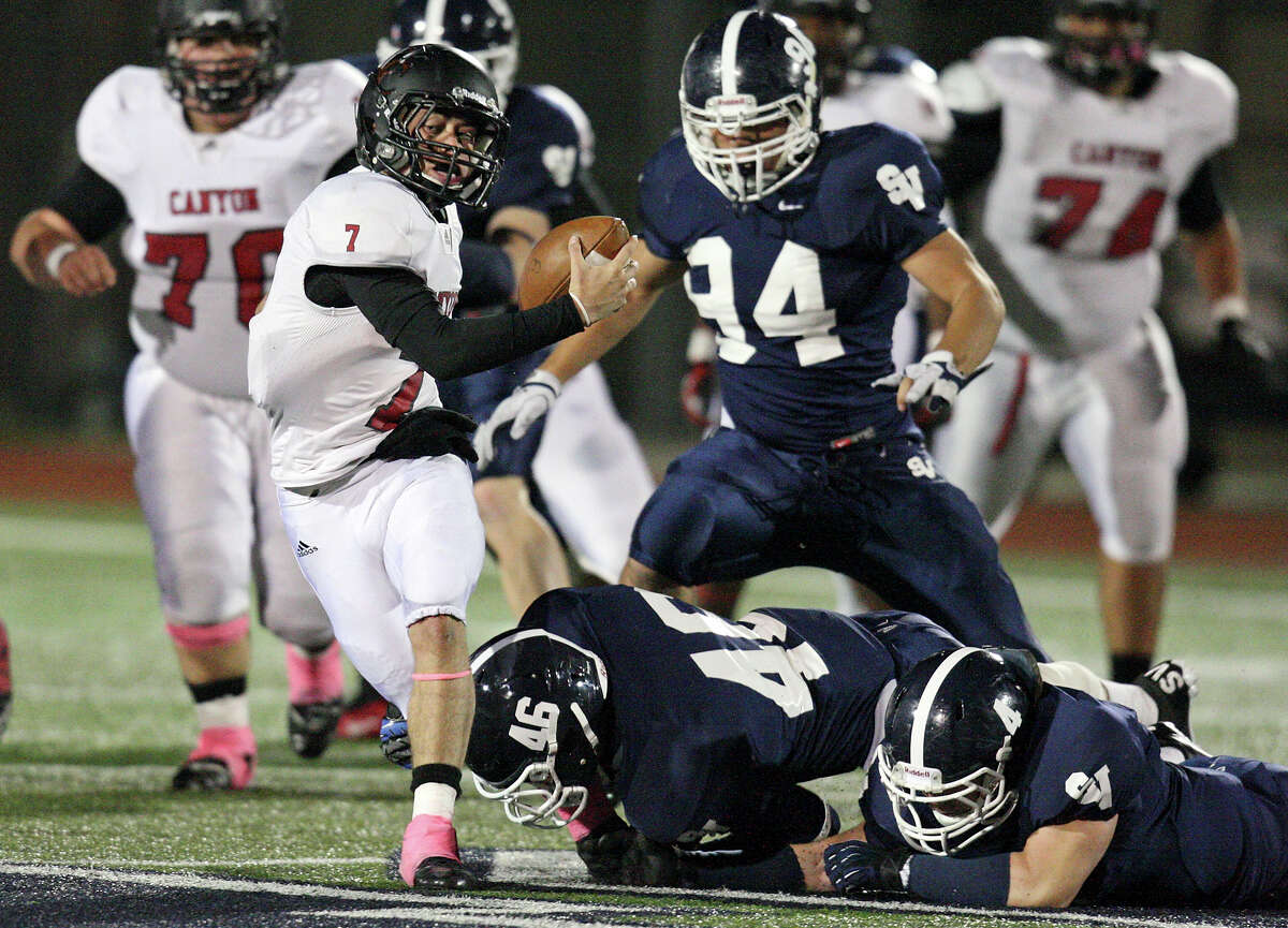 New Braunfels Canyon's Philip Shelton tries to shake the tackle of Smithson Valley's Tristan Wilson and George Schwanenberg during first half action Friday Oct. 26, 2012 at Ranger Stadium in Spring Branch, Tx. Shelton was sacked on the play.