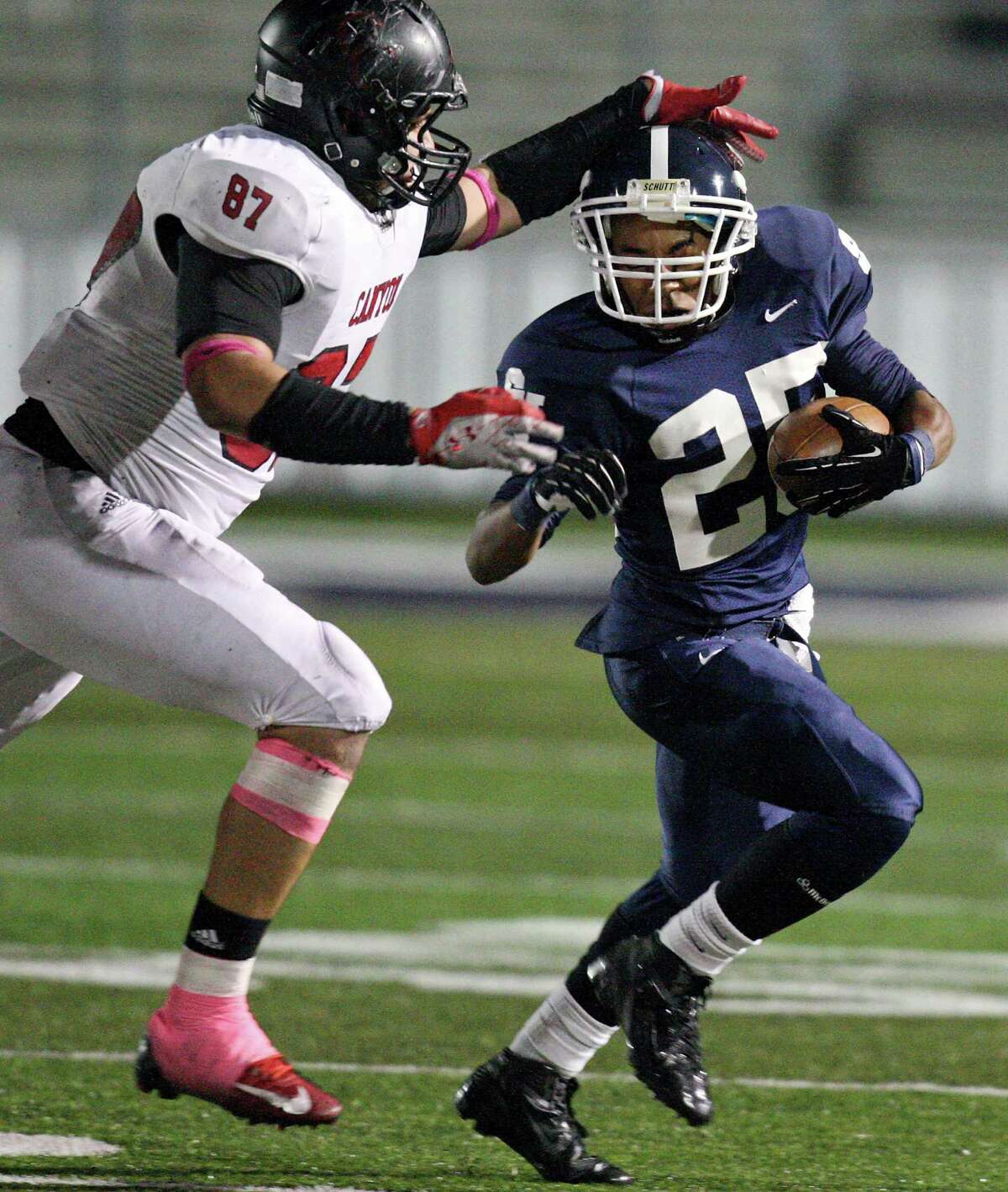 Smithson Valley's Cameron Jones looks for running room around New Braunfels Canyon's Ernest Gonzales during first half action Friday Oct. 26, 2012 at Ranger Stadium in Spring Branch, Tx.