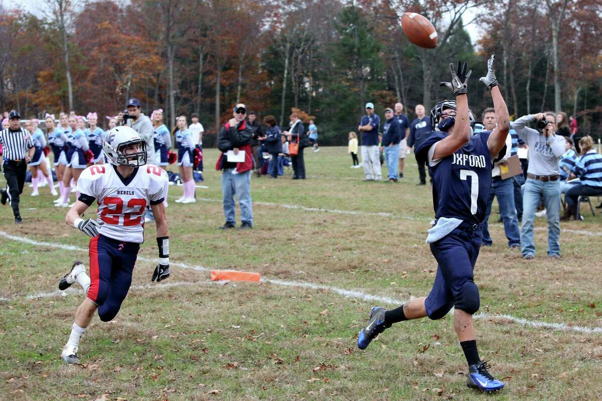 Mike Ross Connecticut Post freelance - Oxford High School's # 7 Chris Vankamerik eyes a touchdown pass as New Fairfield's # 22 Collin Cioffi gives chase during first half action on Saturday
