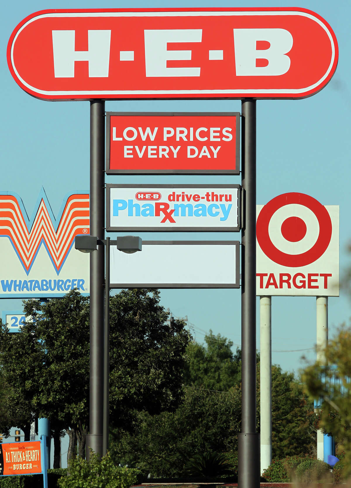 A Target sign is near an H-E-B sign on Southeast Military Drive near Brooks City-Base. H-E-B plans to adapt to increasing competition from stores like Target and Wal-Mart.