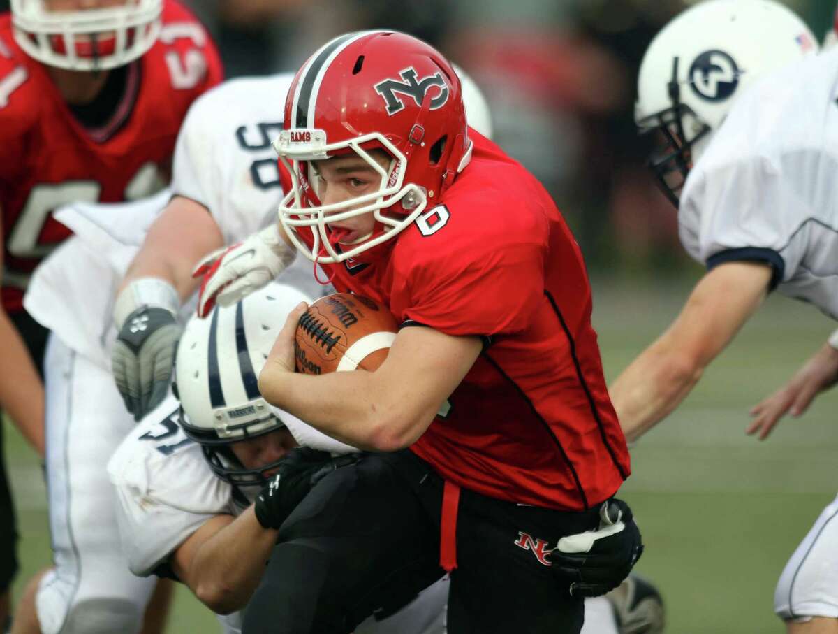 New Canaan QB Teddy Bossidy surges upfield for yardage in New Canaan's 21-14 win over Witon. Bossidy would score on a 46 yard third quarter run to key the New Canaan win.