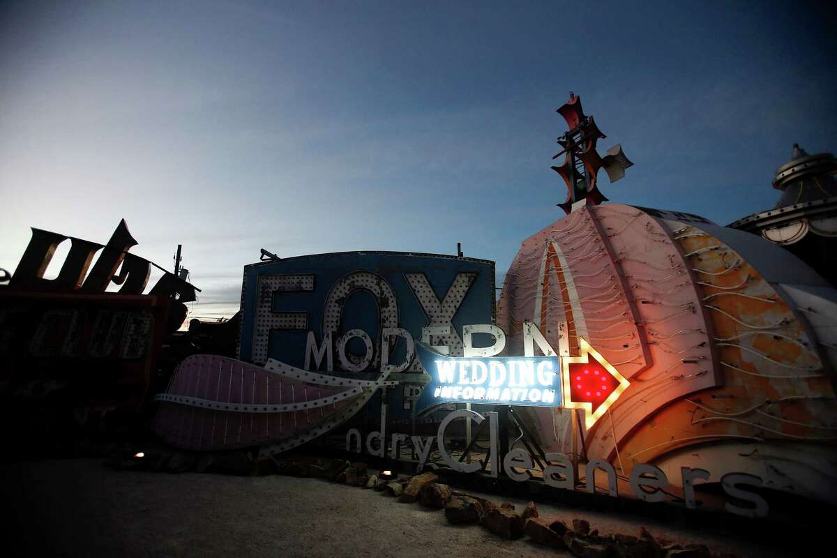 A wedding sign is illuminated during a preopening celebration at the Neon Museum in Las Vegas, Oct. 23, 2012. The museum opened on Saturday, Oct. 27, 2012, after more than 15 years of effort.