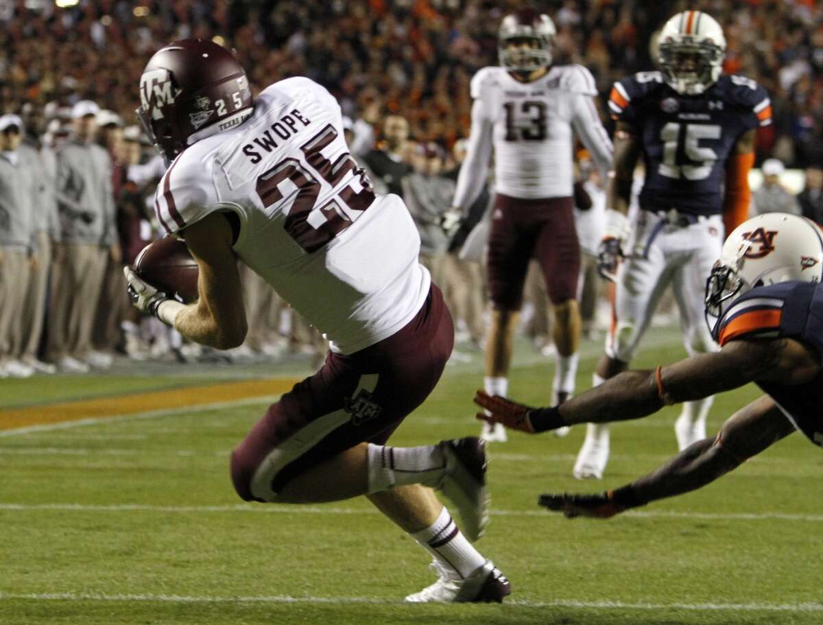 Texas A&M wide receiver Ryan Swope (25) catches a pass for a touchdown past Auburn defensive end Craig Sanders (13) during the first half of an NCAA college football game on Saturday, Oct. 27, 2012, in Auburn, Ala. (AP Photo/Butch Dill) (Associated Press)