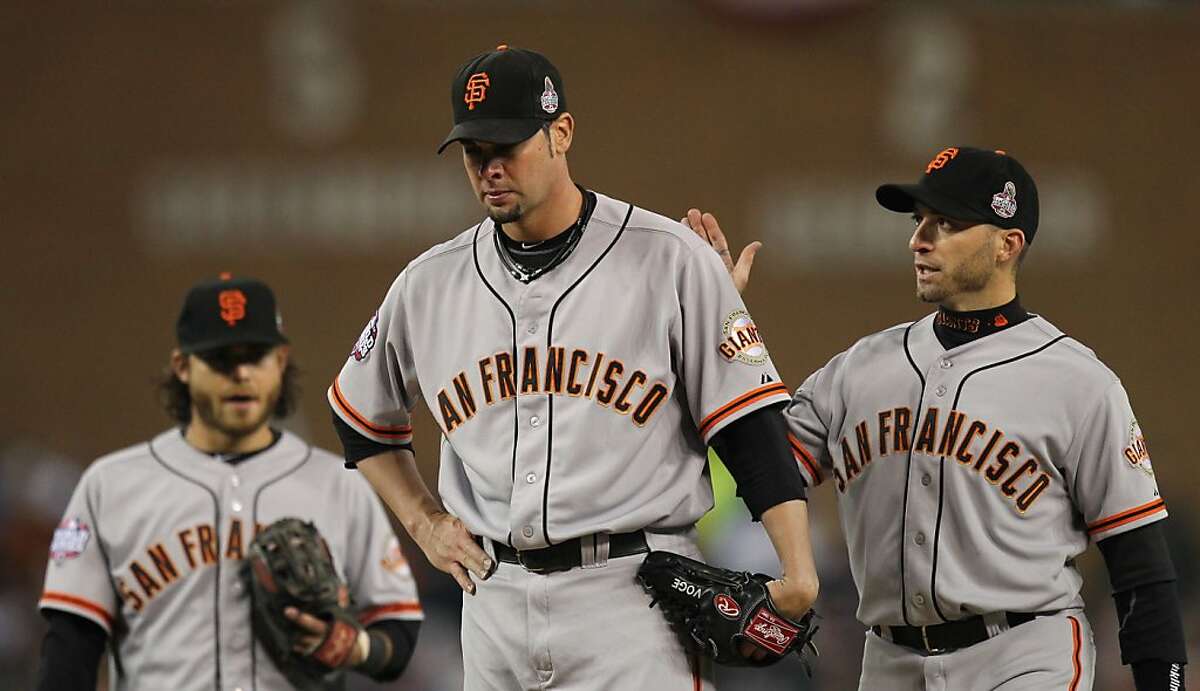 Giants' 2nd baseman Marco Scutaro gives Ryan Vogelsong a pat on the back just before Vogelsong left the game in the 6th inning during game 3 of the World Series at Comerica Park on Saturday, Oct. 27, 2012 in Detroit, MI.