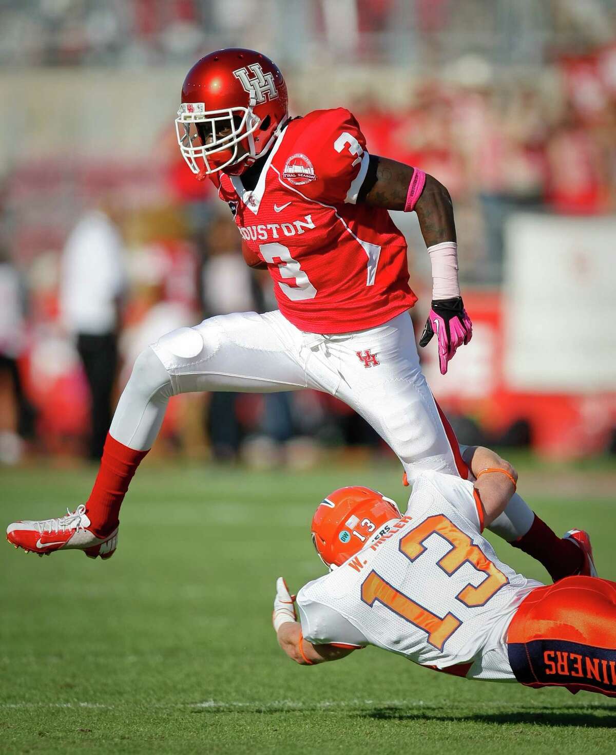 UH's Deontay Greenberry, who caught a touchdown pass from David Piland, tries to step over UTEP defensive back Wesley Miller.