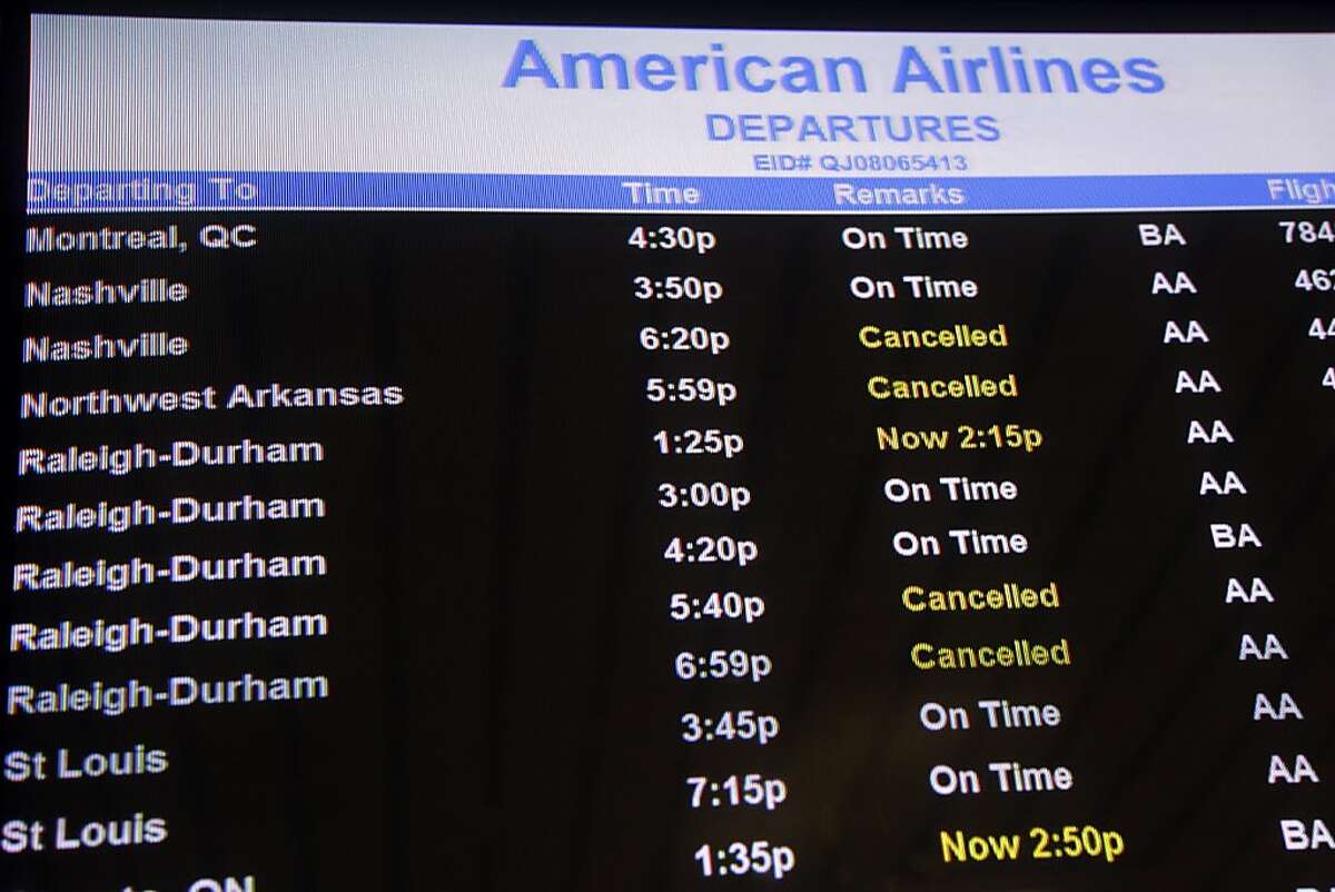 The departures board at the American Airlines terminal at LaGuardia airport shows a few cancellations, Sunday, Oct. 28, 2012 in New York. Tens of thousands of residents were ordered to evacuate coastal areas Sunday as big cities and small towns across the Northeast buttoned up against the onslaught of a superstorm. (AP Photo/Mary Altaffer)