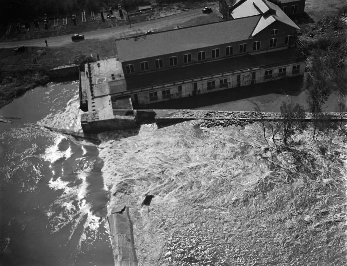 Flood waters were at their crest in the 1938 New England hurricane when this photo was made on Sep. 21, in Providence, R.I. Dockhouses float or stand inundated near the railroad bridge over the Seekonk River. A tog lies wrecked in the bridge's crib work. People and property were swept into the river by winds with gusts up to 186 miles an hour, and carried away. At loast 600 were left dead in New England when the storm passed on after several hours of mad fury. (AP Photo)