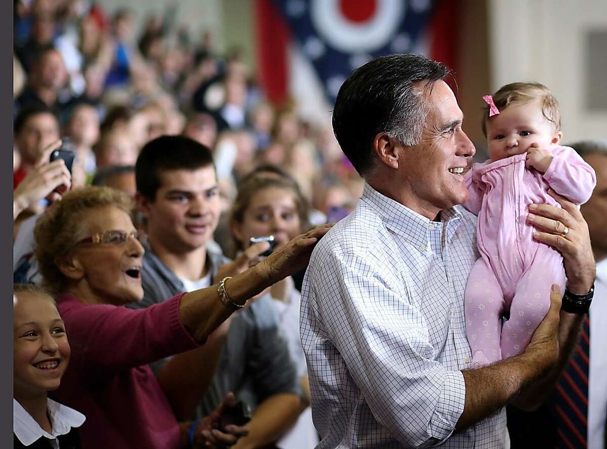 AVON LAKE, OH - OCTOBER 29: Republican presidential candidate, former Massachusetts Gov. Mitt Romney holds a baby during a campaign rally at Avon Lake High School on October 29, 2012 in Avon Lake, Ohio. With less than two weeks before election day, Mitt Romney is campaigning in Ohio, Iowa and Wisconsin. (Photo by Justin Sullivan/Getty Images)