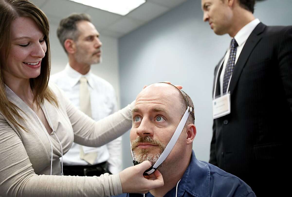 Dr. Michael Callagham, a psychologist from Oakland, gets ready to try transcranial direct current stimulation with the help of Dr. Emily Kappenman from UC Davis at Highland Hospital in Oakland, Calif., Saturday, October 20, 2012. The procedure involves the delivery of a small current to the brain in a targeted area, and has the potential to aid in the treatment of lost motor skills after stroke or brain injury.
