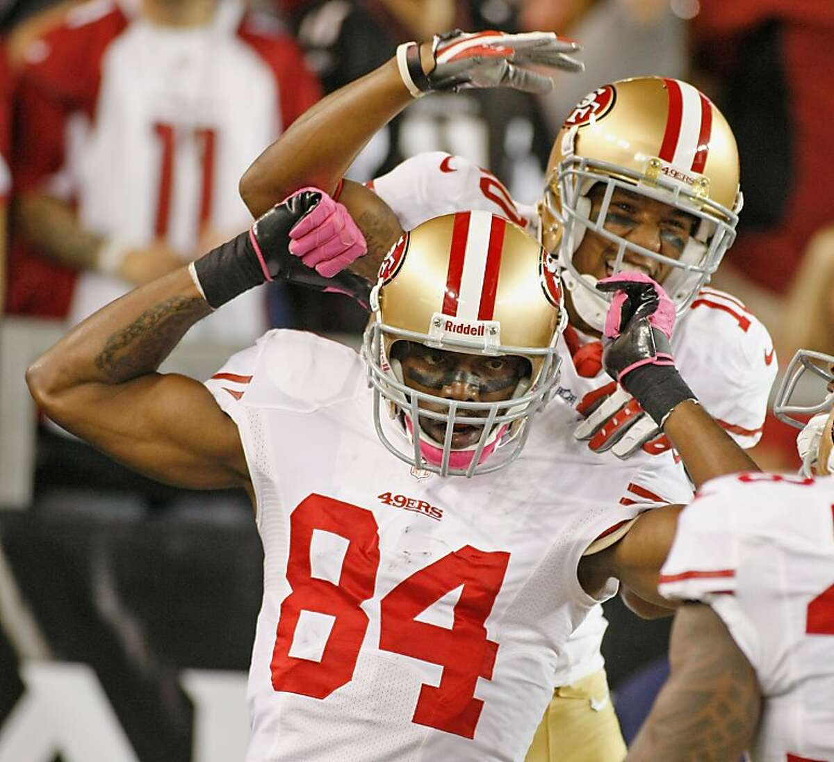 GLENDALE, AZ - OCTOBER 29: Randy Moss #84 of the San Francisco 49ers celebrates with teammate Kyle Williams #10 after his touchdown catch against the Arizona Cardinals during the third quarter of an NFL game at University of Phoenix Stadium on October 29, 2012 in Glendale, Arizona. (Photo by Ralph Freso/Getty Images)