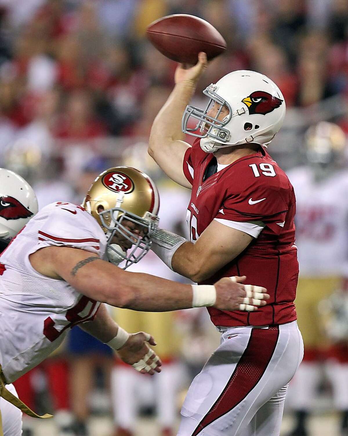 Arizona Cardinals quarterback John Skelton (19) looks to pass under pressure from San Francisco 49ers defensive end Justin Smith during the first half of an NFL football game, Monday, Oct. 29, 2012, in Glendale, Ariz. (AP Photo/Paul Connors)