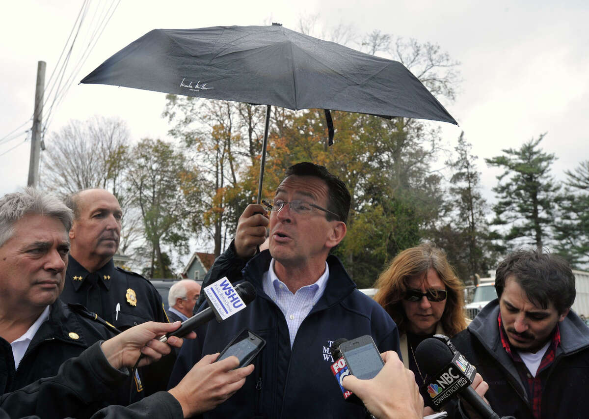 Gov. Dannel P. Malloy addresses the media while touring damage along Shippan Avenue in Stamford, Conn., caused by the effects of Hurricane Sandy on Tuesday, Oct. 30, 2012. To the far left is Stamford Fire Chief Anthony Conte and Police Chief Jon Fontneau.