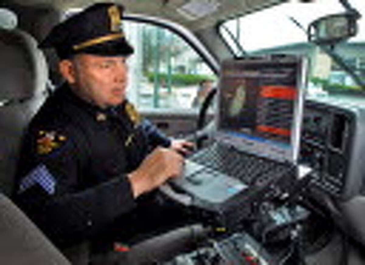 Troy Police Patrol Sgt. Thomas Bevevino monitors the city's shotspotter system from the in-car computer of his patrol supervisor vehicle in Troy Wednesday March 11, 2009. (John Carl D'Annibale / Times Union)