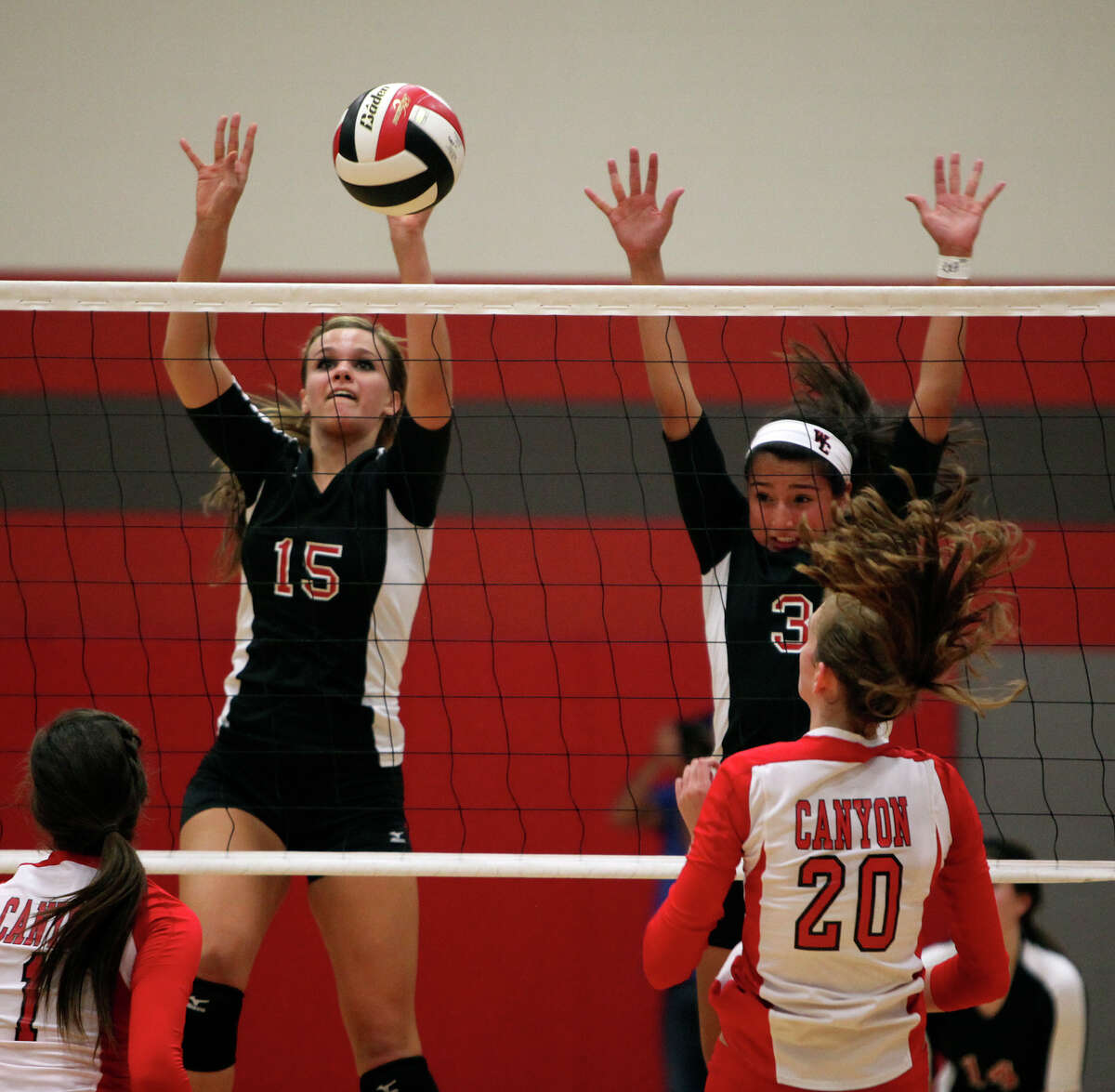 Churchill's Shelby Arnold, left, and Tori Guerra go up against New Braunfels Canyon's Megan Isbell, right, during their Class 5A first round playoff match at Judson High School on Tuesday, Oct. 30, 2012.