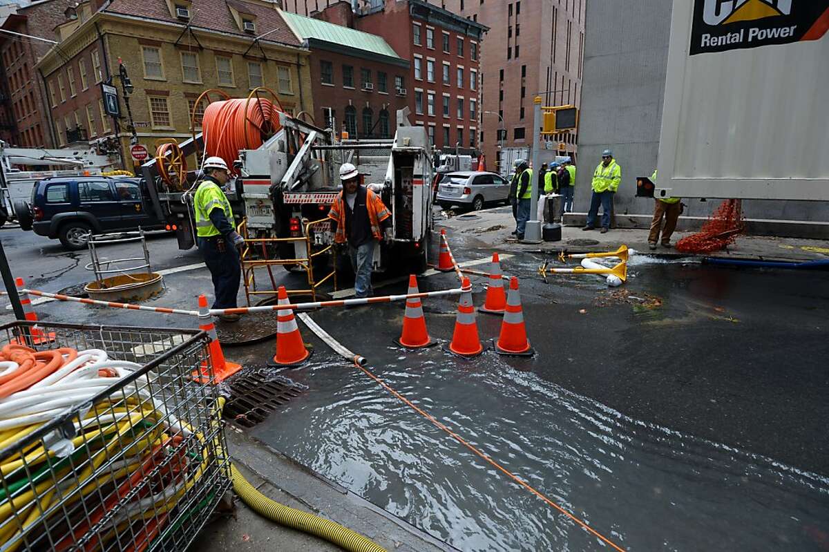 Work crews from Verizon pump water from an access tunnel in Lower Manhattan October 31, 2012 in New York as the city begins to clean up after Hurricane Sandy. AFP PHOTO/Stan HONDASTAN HONDA/AFP/Getty Images