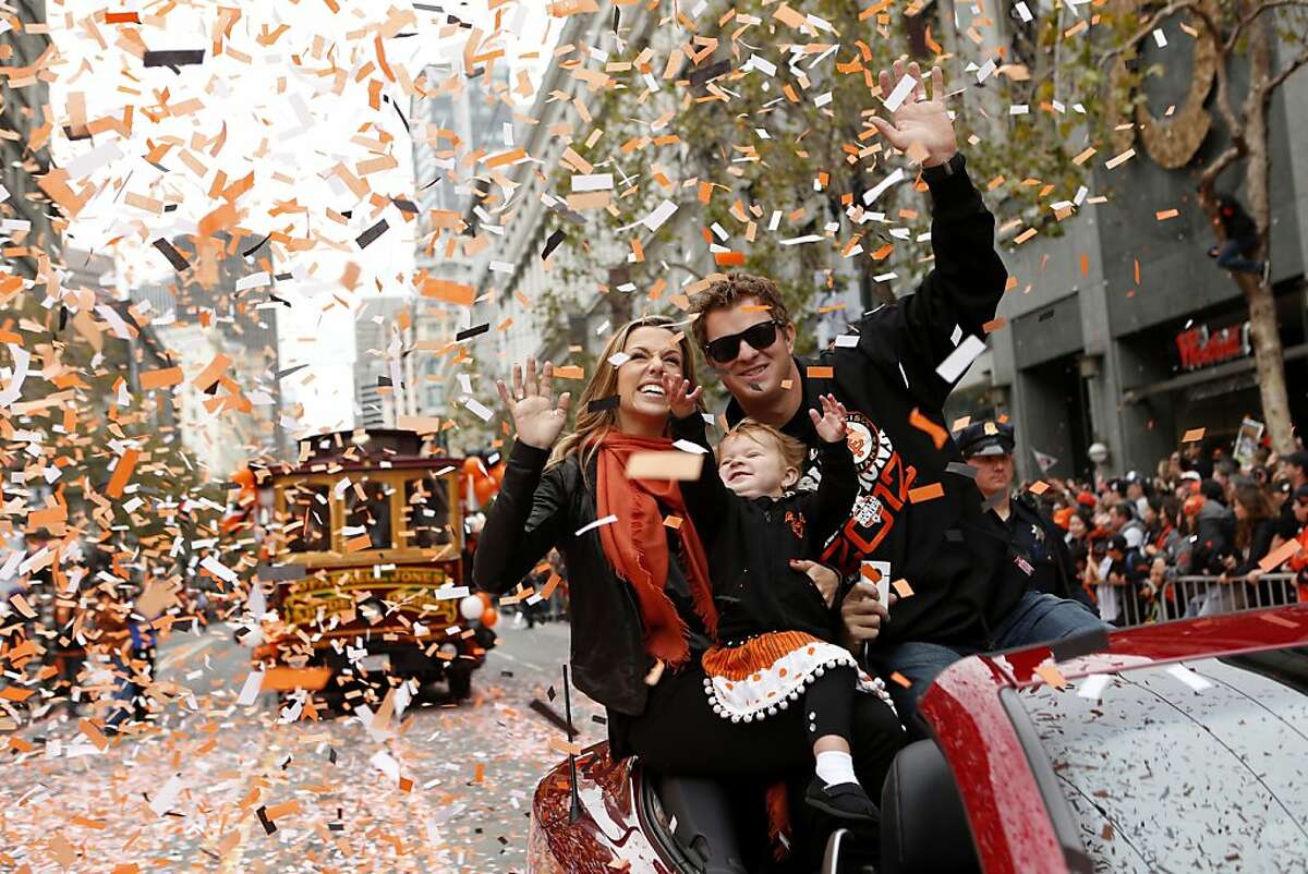 Giants pitcher Matt Cain, wife Chelsea and daughter Hartley wave during the World Series victory parade on Wednesday, October 31, 2012 in San Francisco, Calif.