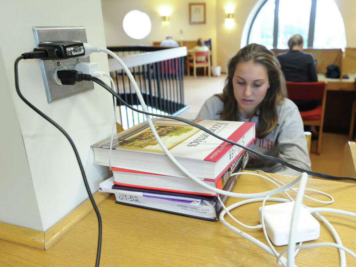 Heather Desino, 16, of Greenwich, plugged in and using the internet at Greenwich Library, Wednesday morning, Oct. 31, 2012. Desino and much of Greenwich are still without electricity due to Hurricane Sandy making the library and its amenities have become a gathering spot for the community.
