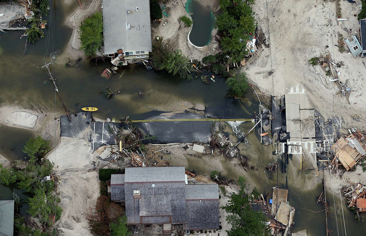MANTOLOKING, NJ - OCTOBER 31: The remains of a road are mired in debris and water from Superstorm Sandy on October 31, 2012 in Mantoloking, New Jersey. At least 50 people were reportedly killed in the U.S. by Sandy with New Jersey suffering massive damage and power outages.