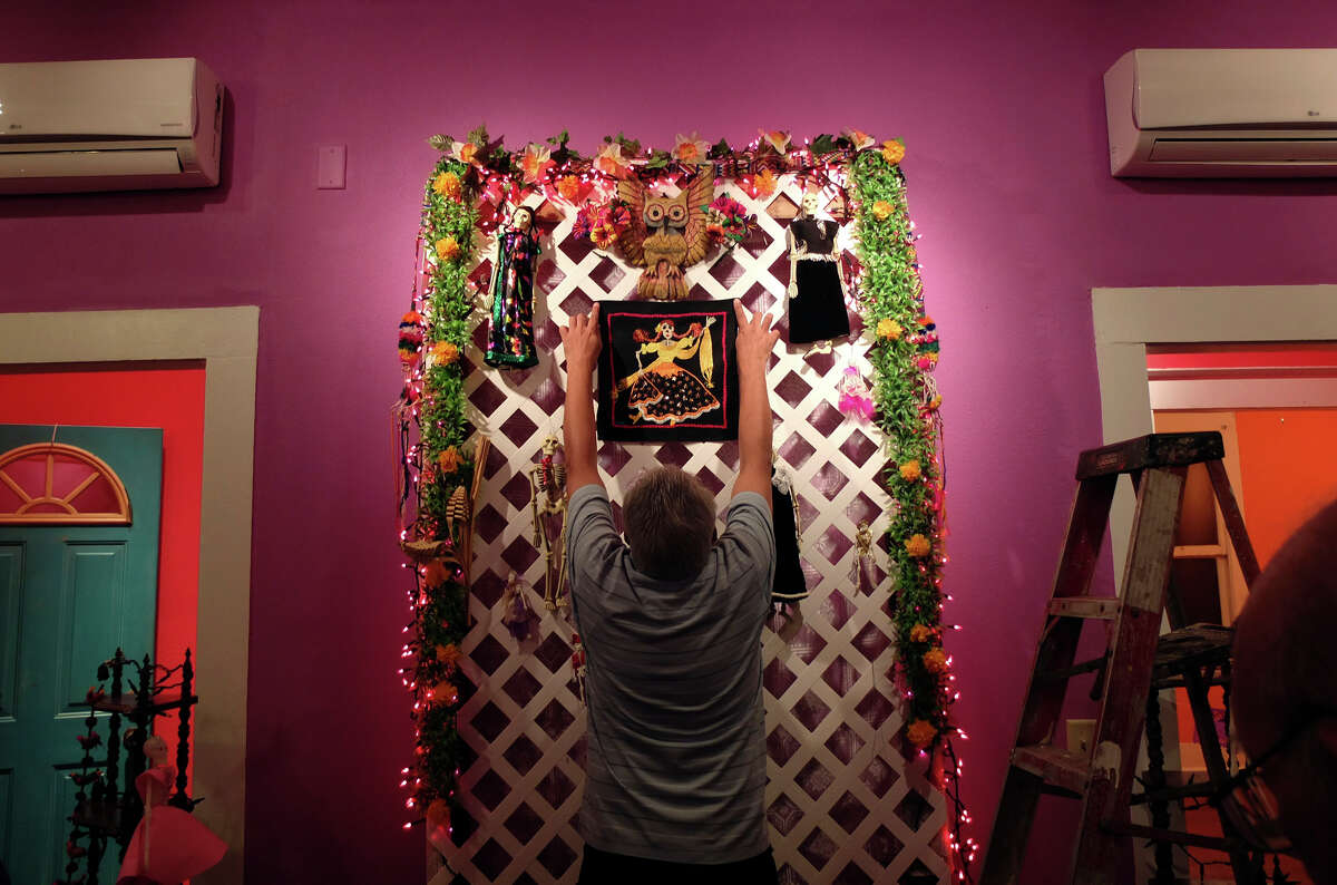Bernard Sanchez positions a decorative panel on an altar for his family at the Rinconcito de Esperanza house on Tuesday, Oct. 30, 2012. About 20 altars were being put in the home which serves as a center for historical preservation for the Westside of San Antonio. A celebration for Dia de Los Muertos will be held at the home on Nov. 1 and will remain on display for 10 days thereafter.