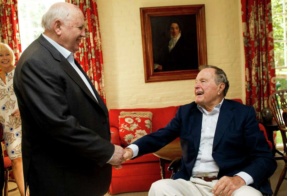 Mikhail Gorbachev, former leader of the Soviet Union, left, greets former President George H.W. Bush before having lunch together Thursday, Nov. 1, 2012, in Houston.
