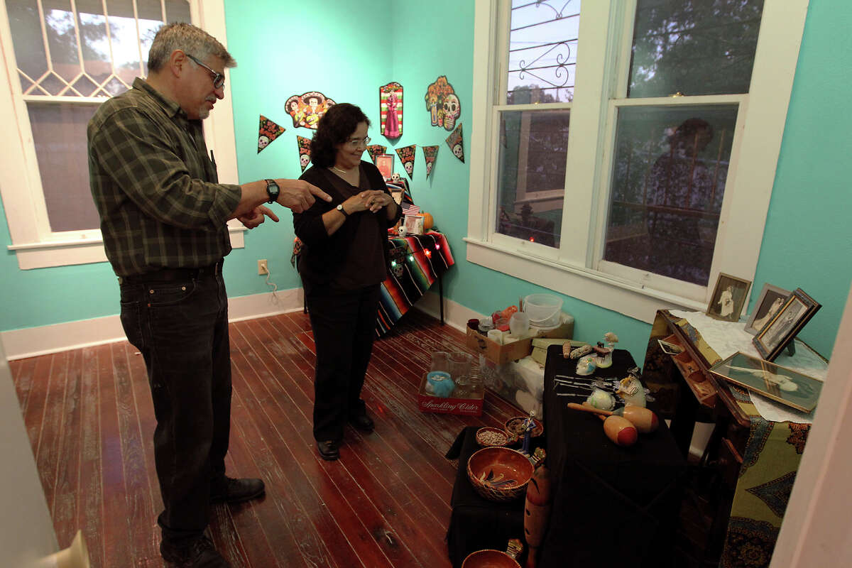 Roland Mazuca (left) talks ideas with Donna Guerra about a Day of the Dead altar he's creating to honor his mother and father at the Rinconcito de Esperanza house on Tuesday, Oct. 30, 2012. About 20 altars were being put in the home which serves as a center for historical preservation for the Westside of San Antonio. A celebration for Dia de Los Muertos will be held at the home on Nov. 1 and will remain on display for 10 days thereafter.