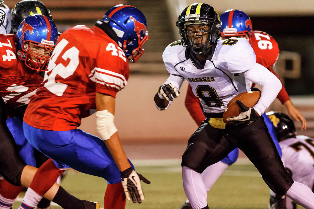 Brennan running back Nathanial Wells Jr (right) looks for running room as Jefferson's Roger Morales comes up to stop him during the second quarter of their game at Alamo Stadium on Nov. 2, 2012. Brennan won the game 14-0 . MARVIN PFEIFFER/ mpfeiffer@express-news.net