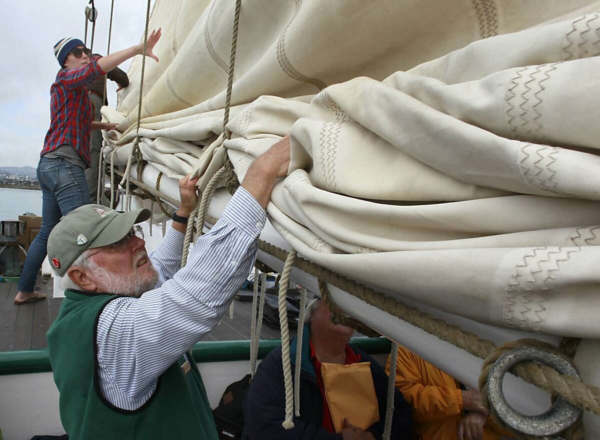 Stacey Fernandez (top) and Tom Hunt lower a main sail as the crew of the historic scow schooner Alma prepares to land at India Basin after a voyage from the Hyde Street Pier in San Francisco, Calif. on Thursday, Nov. 1, 2012. Built in the year 1891, the Alma once plied the shallow water of the Sacramento-San Joaquin delta hauling heavy cargo.