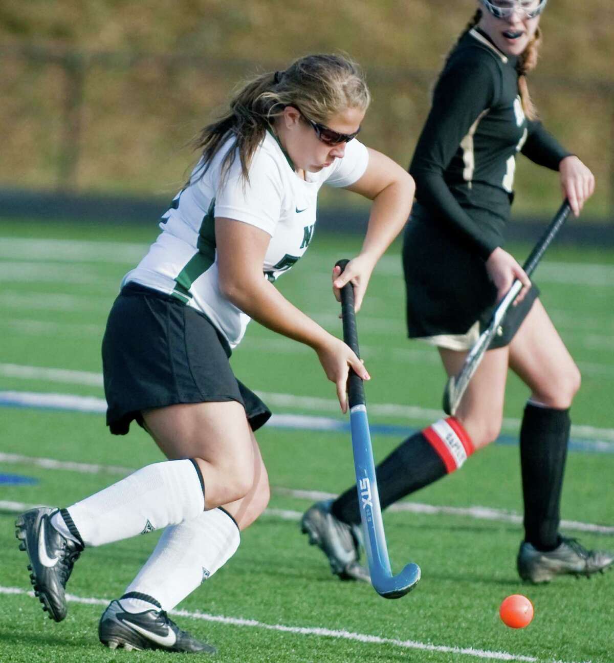 New Milford High School's Lindsey Heaton moves the ball into Joel Barlow High School territory in an SWC field hockey semifinal game at Immaculate. Sunday, Nov. 4, 2012