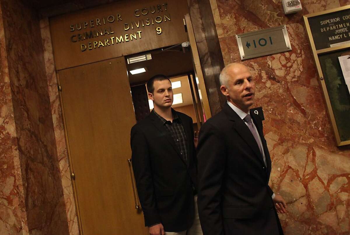 Gregory Graniss (l to r), who allegedly smashed a Muni bus windshield after the San Francisco Giants won the World Series, is seen leaving his arraignment with attorney Douglas Rappaport at the Hall of Justice on Monday, November 5, 2012 in San Francisco, Calif.