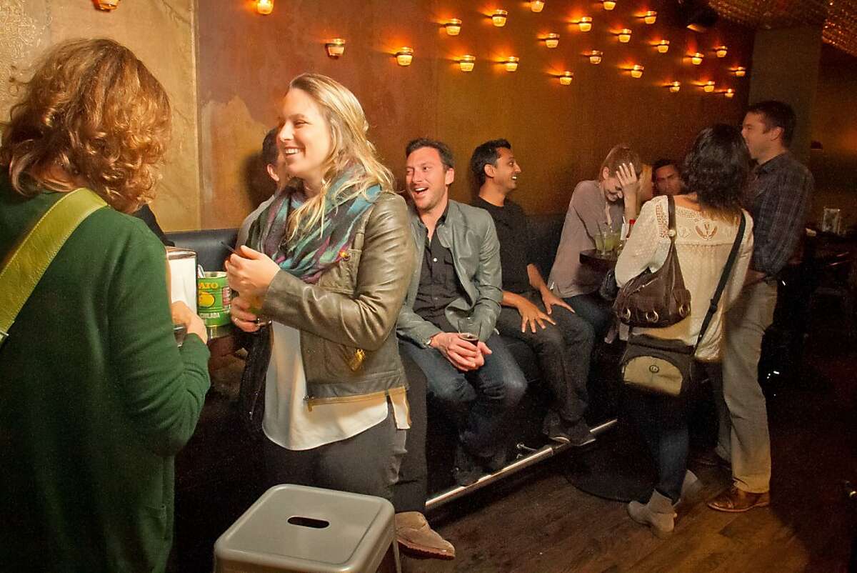 People have cocktails and Tacos at Mosto Bar in San Francisco, Calif., on Friday, November 2nd, 2012.