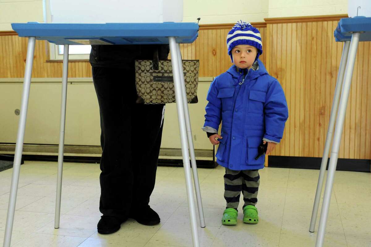 Michael Field, 4, waits for his mother, Ariane, to finish voting Tuesday at Colonie Town Hall in Loudonville. (Cindy Schultz / Times Union)