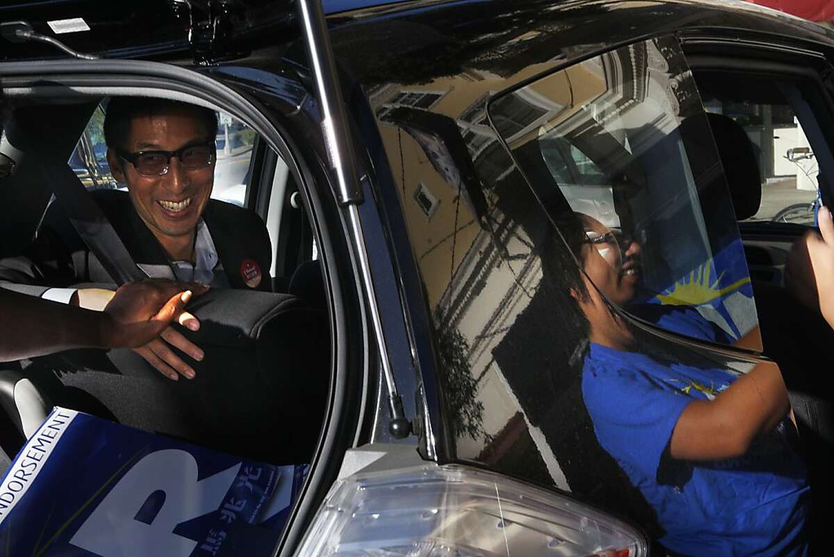 Supervisor Eric Mar (left) greeted by a supporter while getting ready to go to city hall leaving his campaign office in San Francisco, Calif., on Tuesday, November 6, 2012.