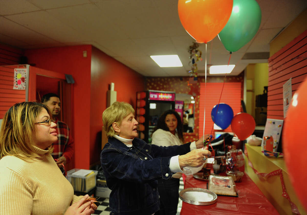 Dottie Guman, Vice-President of the Bridgeport Democratic Town Committee, helps place balloons as campaign volunteer Aidee Nieves looks on, at candidate Christina Ayala's headquarters on East Main Street in Bridgeport, Conn. on Tuesday November 6, 2012. Ayala is the expected winner for the state representative seat in the 128th district.