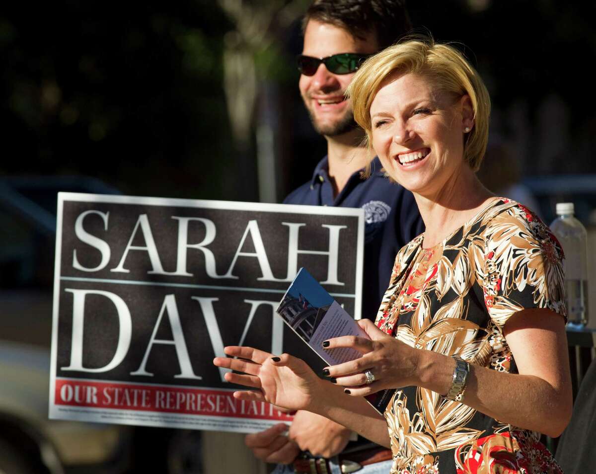 Sarah Davis, Republican candidate running for re-election in the Texas House, stands with Hunter Hughes, as she campaigns near her home precinct at the Colonial Park Recreation Center on Tuesday, Nov. 6, 2012, in West University Place. ( Brett Coomer / Houston Chronicle )