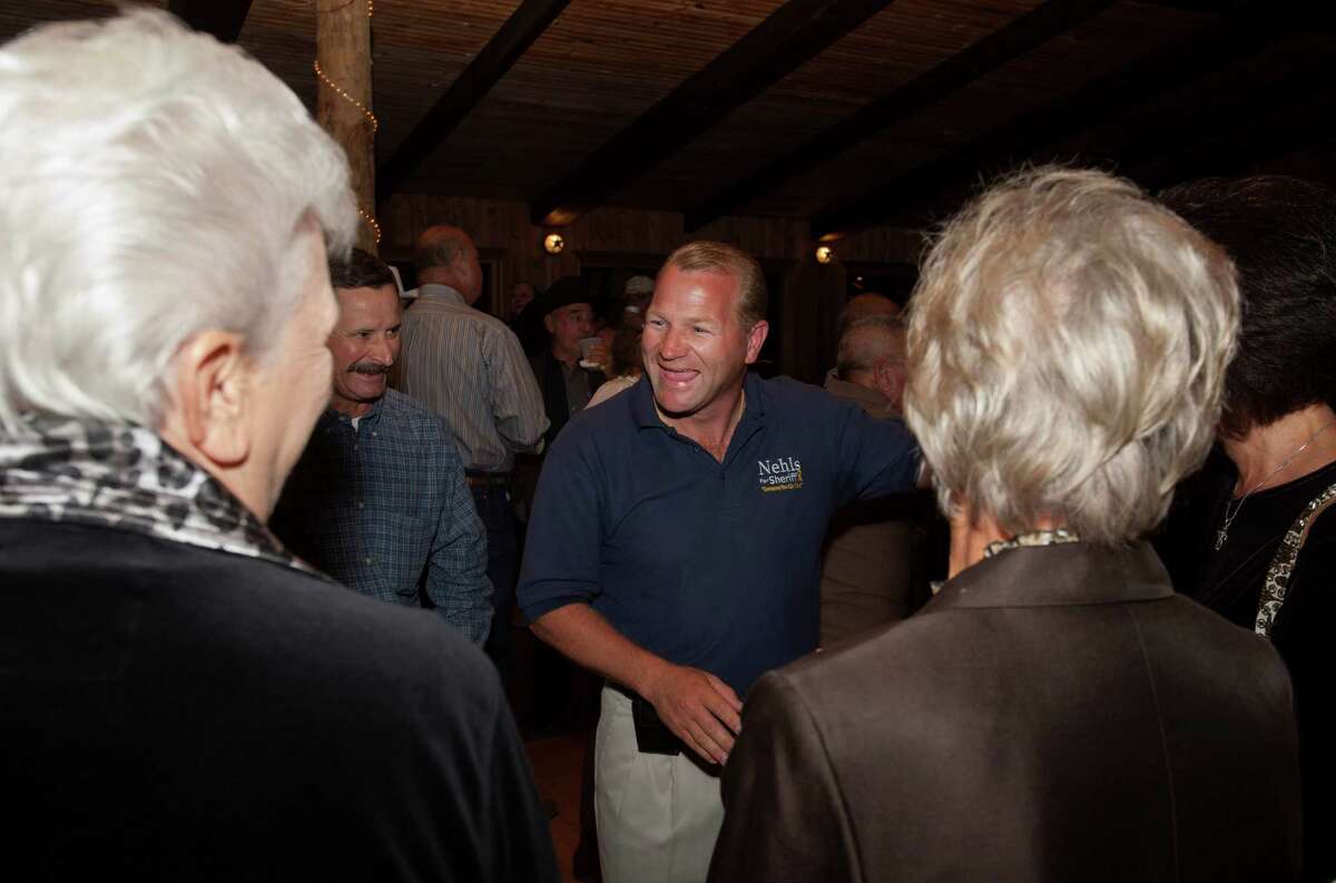 Fort Bend County Sheriff candidate Troy Nehls, center, chats with his supporters on Tuesday, November 6, 2012 at Safari Lodge as they wait for election results in Richmond, Texas. (Bob Levey/For The Chronicle)