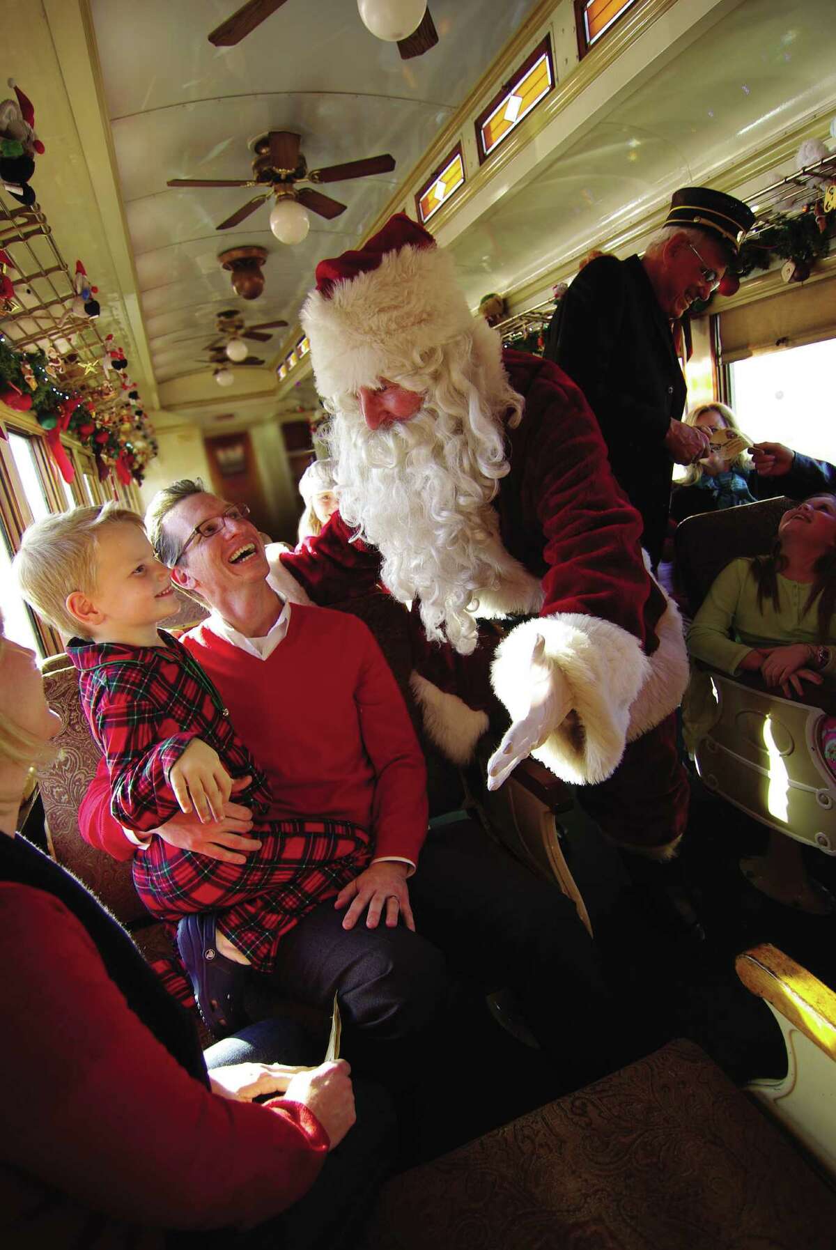 Santa welcomes little ones to a ride on the vintage train dubbed the North Pole Express in Grapevine.