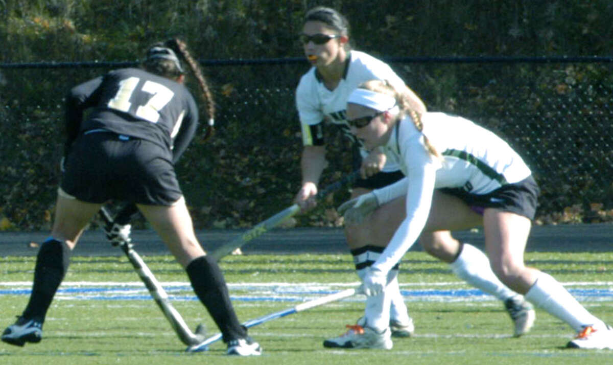 Vienna Pallisco, center, and Taylor Duffany of the Green Wave challenge the Falcons' Marissa Johnson during New Milford High School field hockey's 3-1 victory over Joel Barlow in the South-West Conference playoff semifinals at Immaculate High in Danbury. Nov. 4, 2012