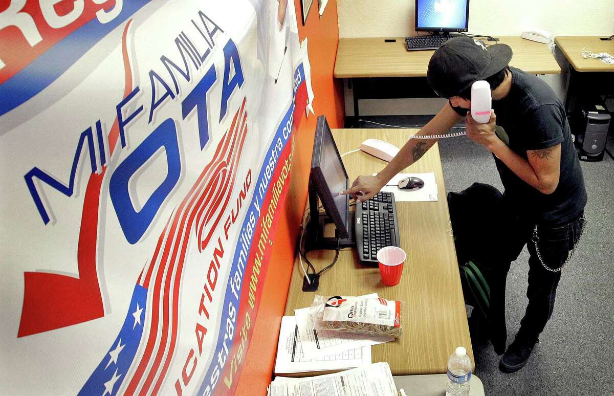 Pedro Yazzie, 27, makes phone calls Tuesday, Nov. 6, 2012 in Phoenix to registered voters from the offices of Mi Familia Vota, a non-partisan effort to increase voter participation among Latinos and others. (AP Photo/Matt York)