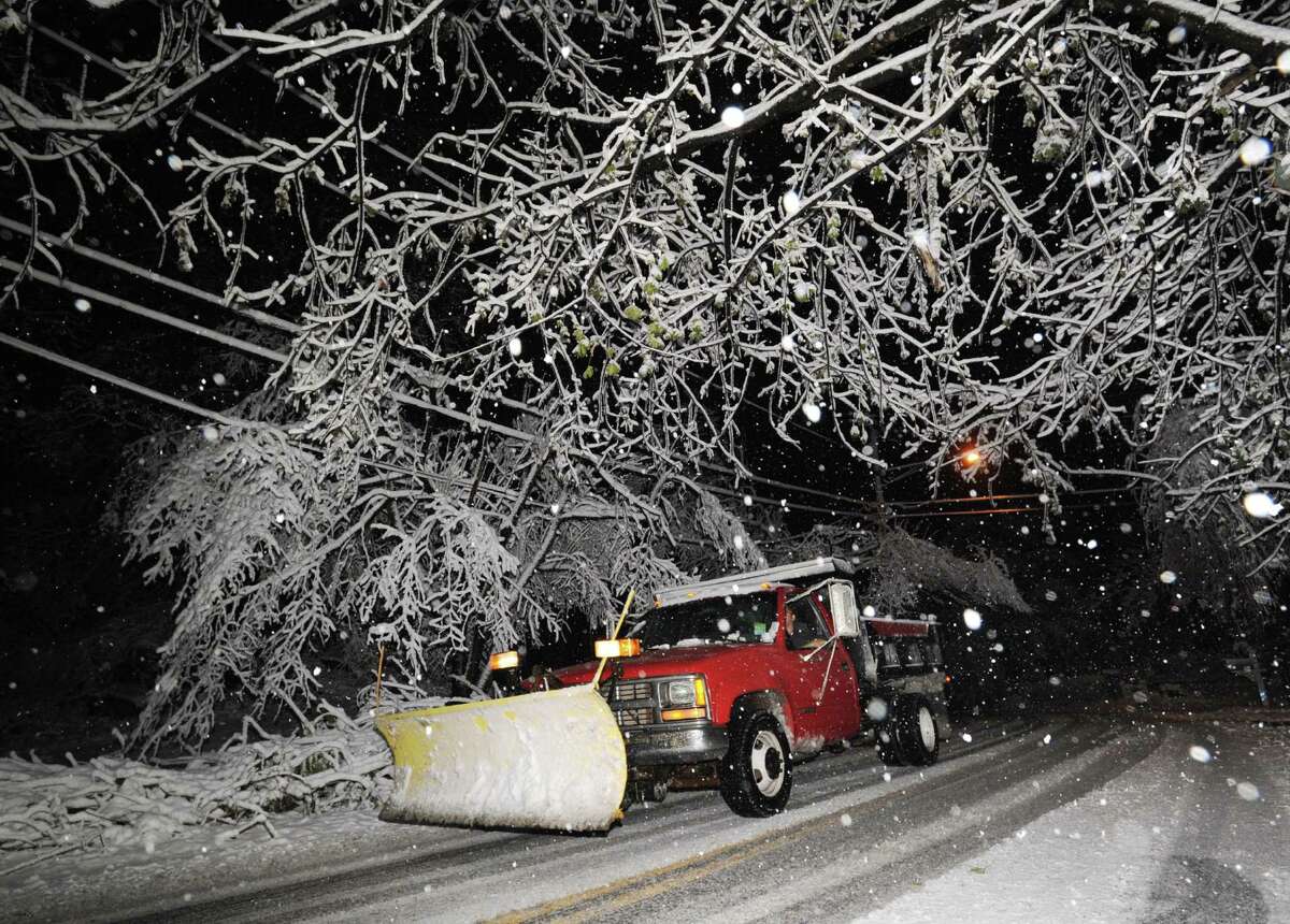 A plow truck makes its way through a snow covered Bruce Park Drive during the nor'easter that hit Greenwich, Wednesday night, November 7, 2012.
