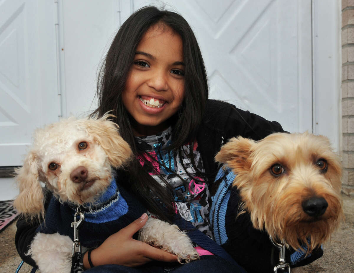 Arianna Rodriguez holds her dogs Skippy and Deuce on the front porch of her Bridgeport, Conn. home Nov. 8th, 2012. Rodriguez has organized a pet food drive in the wake of storm Sandy.