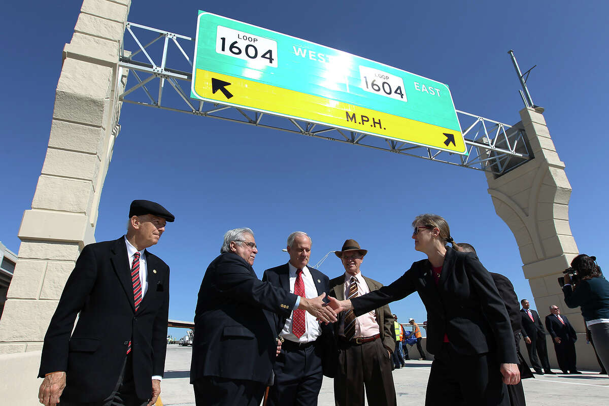 Alamo Regional Mobility Authority Executive Director Terry Brechtel (right) shakes hands with Bexar County Commissioner Paul Elizondo at the unveiling of the new U.S. 281 North to Loop 1604 East and West Direct Connector on Thursday, Nov. 8, 2012. Also in attendance for the unveiling were State Senator Jeff Wentworth (from left), Bexar County Commissioner Tommy Adkisson and Bexar County Judge Nelson Wolff. Construction that began 18 months ago to join the two highways has now been completed and ready to open to traffic.