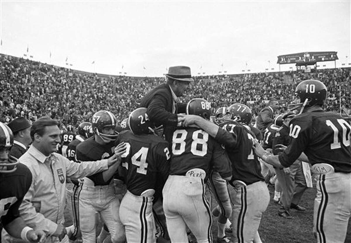 Alabama football players hoist Coach Paul (Bear) Bryant to their shoulders after the Crimson Tide finished an unbeaten, untied season with a 31-0 triumph over Auburn at Birmingham, Alabama, Dec. 5, 1966. Identifiable players are (from left) John Mosley, Ray Perkins, Jerry Duncan and Wayne Trimble.