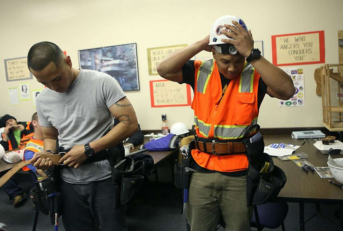 Alan Nudo (left) and Marco Concepcion (right) getting their gear in class during their last day at Carpenters Training Committee for Northern California in Pleasanton, Calif., on Thursday, November 8, 2012. They met in the US marine corps in HQ 1/14 while serving in Iraq.