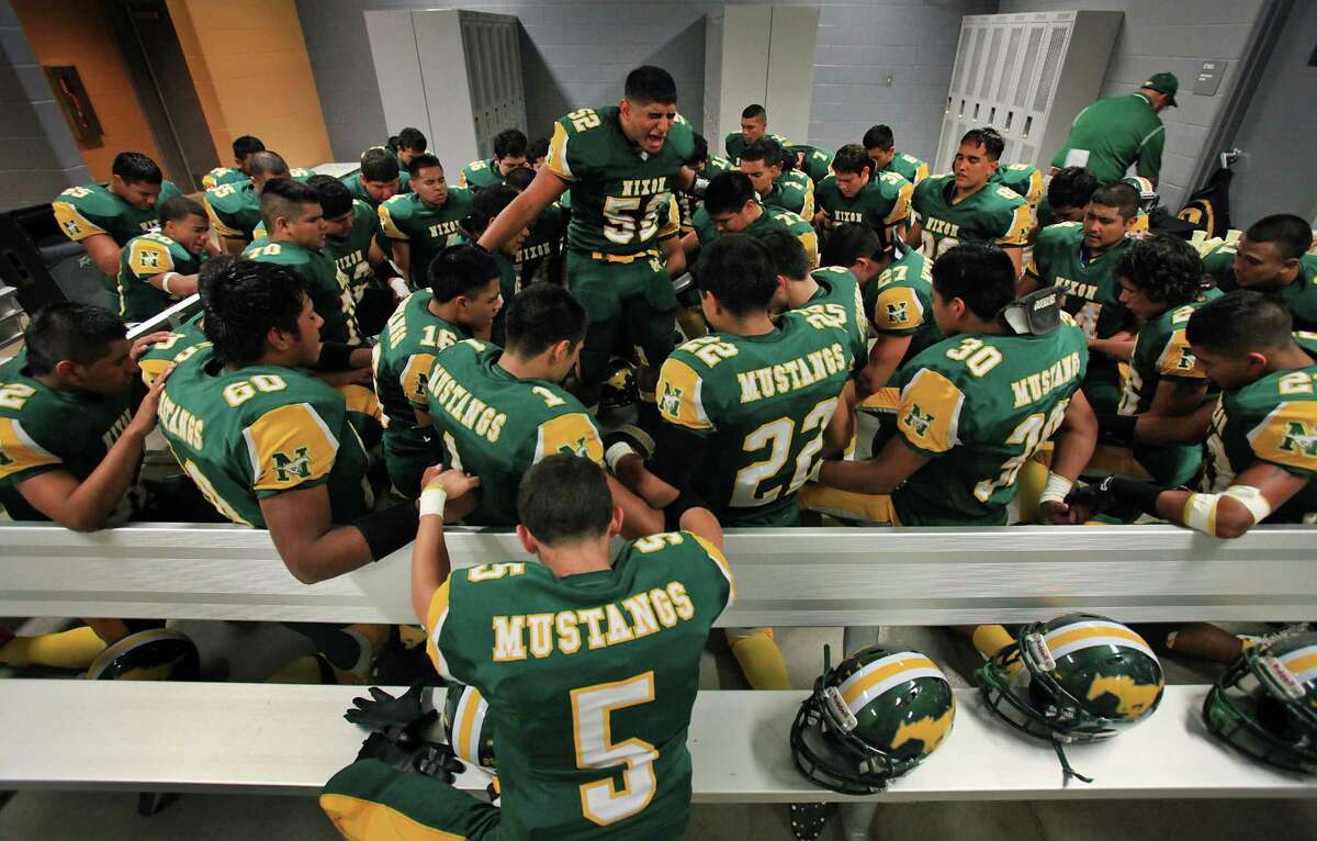 Erick Fernandez, Captain of the Nixon High School football team, leads his team in prayer before their game against Corpus Christi Ray at Shirley Field in Laredo, Friday, Oct. 5, 2012.