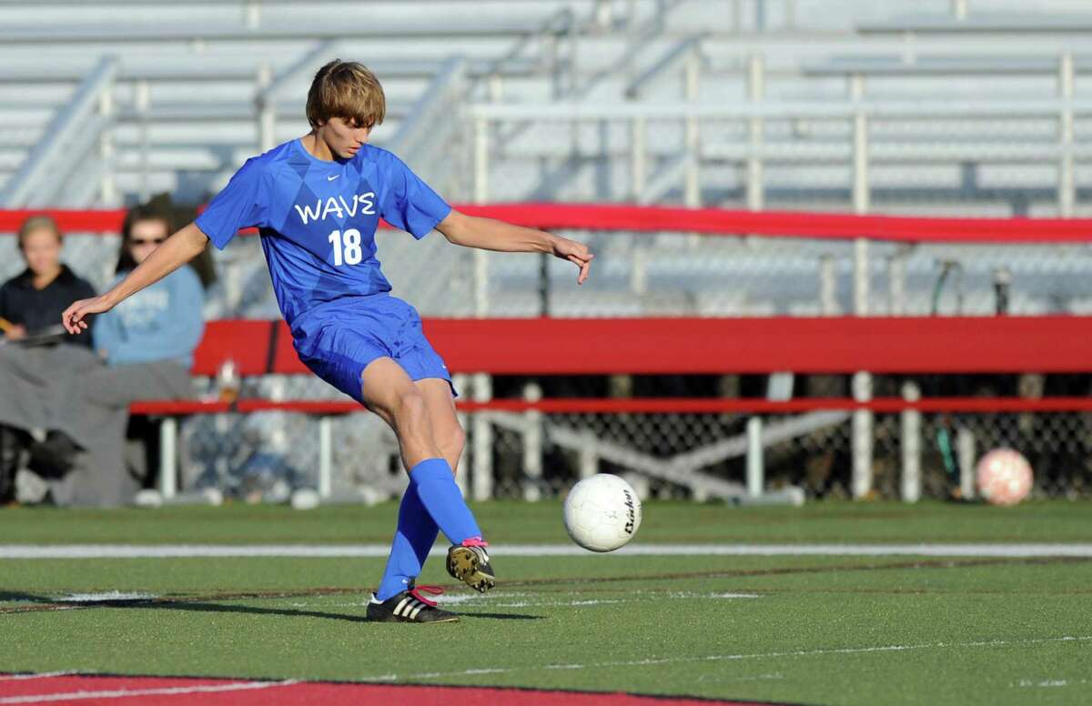 Darien's Marcus Iqbal controls the ball during Friday's soccer game at New Canaan High School on November 9, 2012.